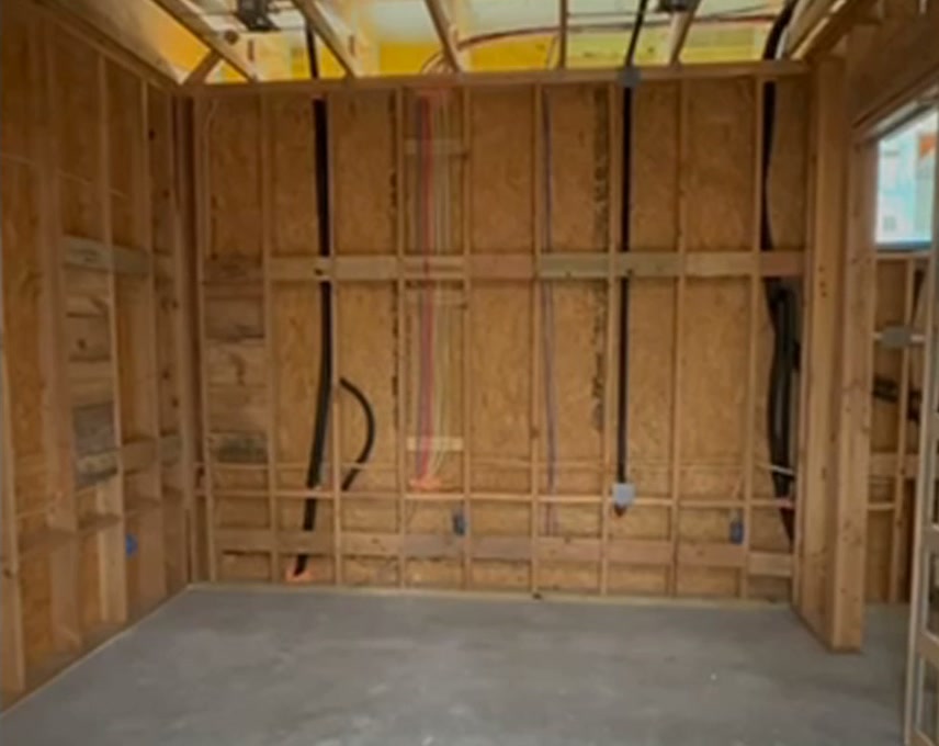 Exposed framing and utilities before drywall